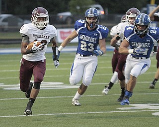 ROBERT  K. YOSAY | THE VINDICATOR.Early in the First quarter action as BDM as #10 Turel Thompson ) rambles for a first down as #23 Adam Wollet and #24 Austin Wilson for Poland in pursuit ..Boardman Spartans at Poland Bulldogs Stadium