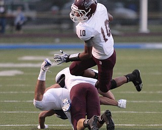 . ROBERT K. YOSAY | THE VINDICATOR..Boardmans #10 Turel Thompson Jumps over teamate 14 Matt Filipovich as he blocks Polands #3 Tyler Evan as he gains 6 yards in the first quarter action..Boardman Spartans at Poland Bulldogs Stadium