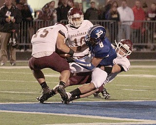  .          ROBERT  K. YOSAY | THE VINDICATOR..Boardmans #15  Gavin Dill Rips the ball from polands #8 Geroge Chammas after a pass and a gain to the 50  tackling George is  #14 Matt Filipovich and looking on is #10 Turel Thompson during third quarter action.Boardman Spartans at Poland Bulldogs Stadium