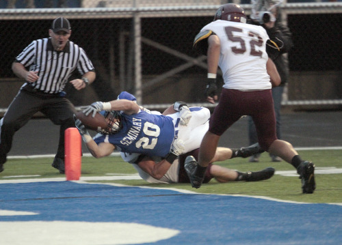  .          ROBERT  K. YOSAY | THE VINDICATOR..Polands #20  Ross Gould  Drags BDM #14 Matt Filipovich and #52 Alex Birchfield as he dives into the endzone for a score.Boardman Spartans at Poland Bulldogs Stadium