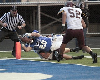  .          ROBERT  K. YOSAY | THE VINDICATOR..Polands #20  Ross Gould  Drags BDM #14 Matt Filipovich and #52 Alex Birchfield as he dives into the endzone for a score.Boardman Spartans at Poland Bulldogs Stadium