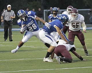  .          ROBERT  K. YOSAY | THE VINDICATOR.Polands #28 Marlon Raimirez makes the cut as .teammate #8 George Chammas  blocks #3 Dari Sanders  during first quarter action.BDM #55 Nick Cordova looks on.Boardman Spartans at Poland Bulldogs Stadium