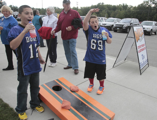  .          ROBERT  K. YOSAY | THE VINDICATOR..Andrew Parket and Zach Ellis Both from Poland and 11 years old react to a score at the  Corn Hole..Boardman Spartans at Poland Bulldogs Stadium