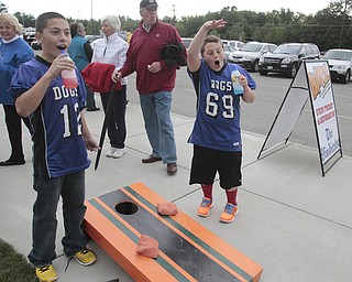  .          ROBERT  K. YOSAY | THE VINDICATOR..Andrew Parket and Zach Ellis Both from Poland and 11 years old react to a score at the  Corn Hole..Boardman Spartans at Poland Bulldogs Stadium