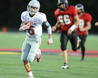 Dover receiver #6 Cory Contini sprints int he open field toward the end zone after catching a pass in stride behind the Canfield defense during the first half of a game on September 13, 2013 against Dover.  Canfield #66 Jacob Esarco and #68 Charles Sinclair  pictured. This was int he first minute of the game.