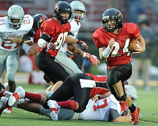 Canfield running back #24 Lzuke Whittenberger sprints int he open field after following the block of a offensive linemen during the first half of a game on September 13, 2013 against Dover. Canfield #80 Cameron Tareshawty pictured.