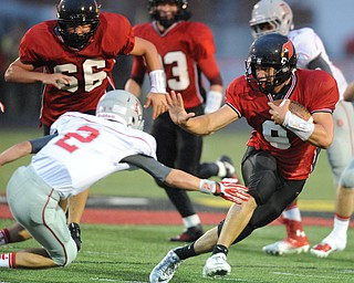 Canfield running back #9 Kimu Kim stiff arms Dover defensive back #2 Evan Snyder during the first half of a game on September 13, 2013 against Dover.