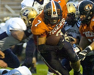 Kelli Cardinal/The Vindicator .Springfield ball carrier Anthony Scandy is brought down Friday night by Lowellville defenders at Springfield High School.