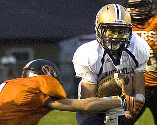 Kelli Cardinal/The Vindicator .Lowellville junior Phil Ginnis avoids the tackle Friday night against Springfield defender Ian Grdina (ok) at Springfield High School.