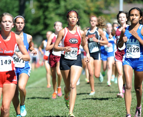 A Girard runner sprints in the pack on the back stretch during the Girls Division 2 race on Saturday September 14, 2013 at Boardman High School.