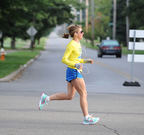A runner runs across the interception of South Belle Vista Ave and McCollum Road in Youngstown during the half marathon early Sunday morning as part of the Green Cathedral race on September 15, 2013.