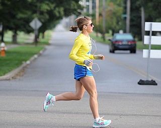 A runner runs across the interception of South Belle Vista Ave and McCollum Road in Youngstown during the half marathon early Sunday morning as part of the Green Cathedral race on September 15, 2013.