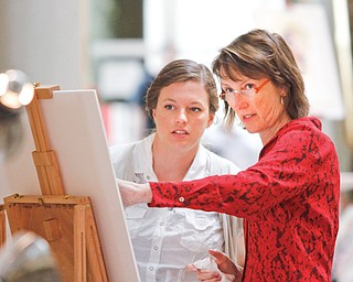 Mary Whyte shows Amelia Spade, from Montana, the effects of lighting on their subject during Whyte’s workshop at The Butler Institute of American Art.