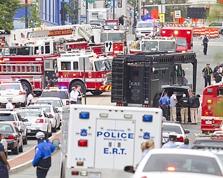 An Emergency Response Team vehicle arrives to the scene where a gunman was reported at the Washington Navy Yard on Monday. The gunman launched an attack inside the military installation, spraying gunfire on office workers in the cafeteria and in the hallways.