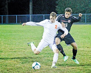 Howland’s Matt Doan (2) kicks the ball away from Canfield’s Nick Phillips (15) during their scoreless match on
Tuesday in Howland.