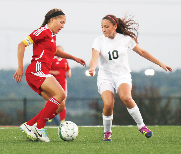Mooney’s Juliana Vazquez, left, and Ursuline’s Kali Kerpelis battle for possession of the ball during a soccer match Wednesday at Youngstown State Univerity. The Cardinals shut out the Irish, 7-0.