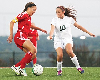 Mooney’s Juliana Vazquez, left, and Ursuline’s Kali Kerpelis battle for possession of the ball during a soccer match Wednesday at Youngstown State Univerity. The Cardinals shut out the Irish, 7-0.