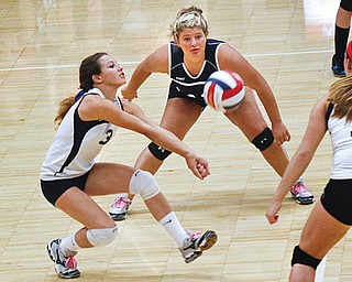 Fitch’s Cali Mikovich (3) digs the ball while Alex Corradi (43) and Sydney Greenwood (17) watch Thursday night.