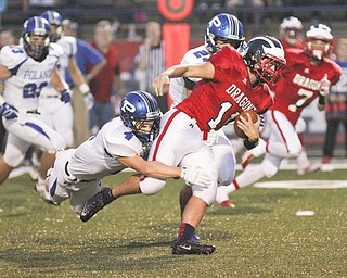 William D Lewis The Vindicator Niles John Cicero (11) is stopped by Poland's Dylan Garver(4) during first quarter action Friday 9-20-13 action at Niles.