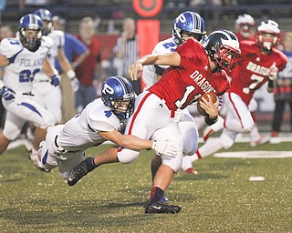 William D Lewis The Vindicator  Niles John Cicero (11) is stopped by Poland's Dylan Garver(4) during first quarter action Friday 9-20-13 action at Niles.