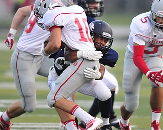 Fitch #31 Tyler Hewlett wraps up Dover receiver #10 Shay Smith on a bubble screen pass early in the first quarter.