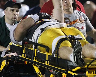 Youngstown Cardinal Mooney's Nick Bilas raises his fist as he is removed from the field after he was injured playing against St. Vincent - St. Mary's in the second quarter of a high school football game at St. Vincent - St. Mary High School on Friday, Sept. 20, 2013, in Akron, Ohio. (Michael Chritton/Akron Beacon Journal)