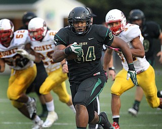 St. Vincent - St. Mary's Newman Williams carries for a first down against Youngstown Cardinal Mooney in the first quarter of a high school football game at St. Vincent - St. Mary High School on Friday, Sept. 20, 2013, in Akron, Ohio. (Michael Chritton/Akron Beacon Journal)
