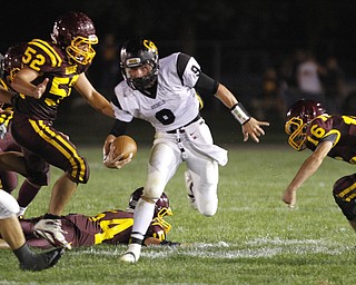  .          ROBERT  K. YOSAY | THE VINDICATOR..BIG HOLE as Crestviews #9 Collin Gilber QB goes through a big whole as #52 South Range Zach Baird  #54 (on ground) Ben Baird and#16  Zach Thorpe can only watch as he scampers for a first down during second quarter action..Crestview @ South Range in North Lima