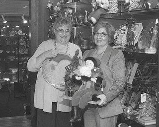 SPECIAL TO THE VINDICATOR
The Youngstown Symphony will host its annual trunk show and sale Oct. 5. Above are Mercy Komar,
left, committee chairwoman, and Monica Rafoth, representing Adamas Jewelry and Gifts, one of
several vendors.