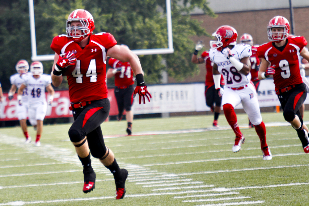MADELYN P. HASTINGS | THE VINDICATOR..YSU's Nate Adams (44) runs to score a touchdown during their game against Duquesne at Stambaugh Stadium on Saturday, September 21. .... - -30-..