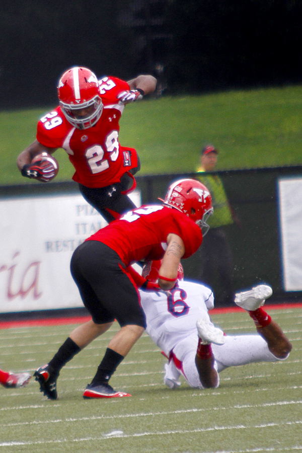 MADELYN P. HASTINGS | THE VINDICATOR..YSU's Martin Ruiz (29) leaps over teammate Christian Bryan (2) and Duquesne's Devin Williams (6) during their game at Stambaugh Stadium on Saturday, September 21. ... - -30-..