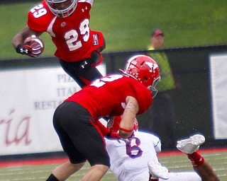 MADELYN P. HASTINGS | THE VINDICATOR..YSU's Martin Ruiz (29) leaps over teammate Christian Bryan (2) and Duquesne's Devin Williams (6) during their game at Stambaugh Stadium on Saturday, September 21. ... - -30-..
