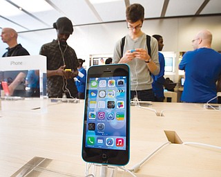 In Montreal, customers in check out the latest versions of the iPhone that went on sale Friday. It was the first time Apple released two iPhone models at once. New testing has shown that the latest models aren’t as durable as last year’s iPhone5.