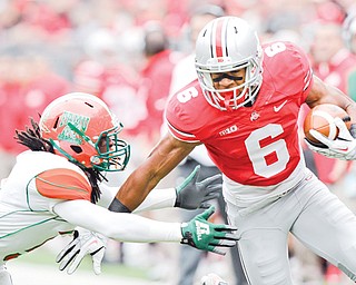 Ohio State wide receiver Evan Spencer (6) tries to escape the grasp of Florida A&M cornerback Patrick Aiken during the first quarter of a game in Columbus. The Buckeyes open Big Ten play Saturday when they take on
Wisconsin.