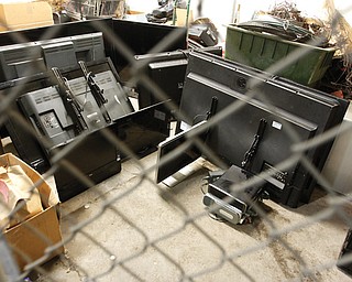 Flat-screen televisions and other electronic goods that were taken from a Ravine Road home Tuesday sit in storage at the Youngstown Police Department.