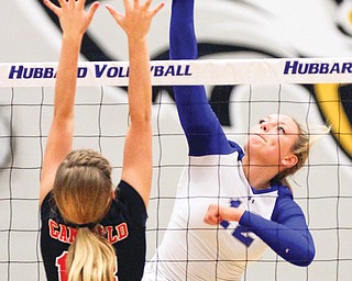 Hubbard’s Caitlin O’Hara (12) goes up for a spike as Canfield’s Madison Stewart (18) tries to make a block
at the net Tuesday night. Hubbard won in four games, 19-25, 25-21, 26-24, 25-13.