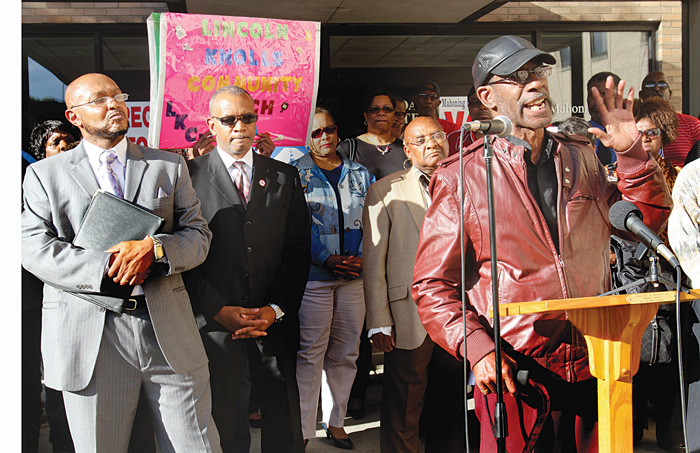 Steven Mickel, right, of the Youngstown NACCP speaks outside the Board of Elections at Oakhill Renaissance Place on the South Side during the rally. Others taking part in the event included, from left the Rev Kenneth Simon, New Bethel Baptist Church; Thomas Conley, of the Greater Warren- Youngstown Urban League and Gillam.
