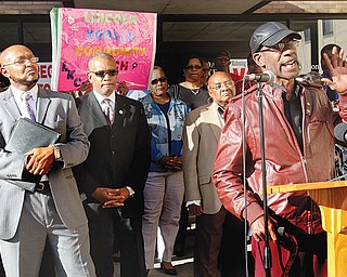 Steven Mickel, right, of the Youngstown NACCP speaks outside the Board of Elections at Oakhill Renaissance Place on the South Side during the rally. Others taking part in the event included, from left the Rev Kenneth Simon, New Bethel Baptist Church; Thomas Conley, of the Greater Warren- Youngstown Urban League and Gillam.
