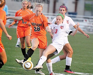 Howland’s Morgan Scott (28) and Canfield’s Kelsey Yankush vie for control of the ball during their soccer match Wednesday in Canfield. The Cardinals edged the Tigers, 2-1.
