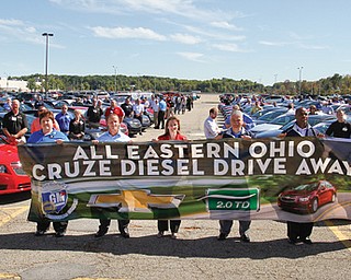 Representatives from 61 dealerships from throughout eastern Ohio gathered Thursday at the General Motors Lordstown Complex to drive off with new Chevrolet Cruze Clean Turbo Diesel cars, which the sprawling auto plant started to manufacture in April. The event marked the official rollout of the model.