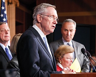 Senate Majority Leader Harry Reid of Nevada speaks at a news conference Thursday to blame conservative
Republicans for holding up a stopgap spending bill over their opposition to Obamacare.