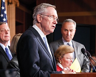 Senate Majority Leader Harry Reid of Nevada speaks at a news conference Thursday to blame conservative
Republicans for holding up a stopgap spending bill over their opposition to Obamacare.