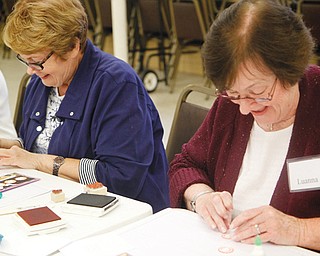 Regina Jenkins, left, and Luanna Jacobs smile and laugh as they craft handmade cards during a Divine Designs gathering at St. James Episcopal Church in Boardman. The sessions take place two Sundays a month.