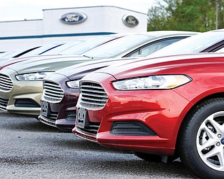 A row of 2013 Ford Fusions is seen at a dealership in Zelienople, Pa. There has been a boom in sales of new cars in the U.S. as consumers have been replacing vehicles they kept through the recession.