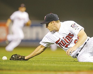 Twins pitcher Andrew Albers cannot to stop a bunt by the Indians’ Asdrubal Cabrera in the fourth inning of Thursday’s game in Minneapolis. Albers fielded the ball to first, but Cabrera reached safely on an error by first baseman Chris Colabello. The Indians won the game 6-5.