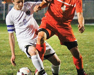 Lakeview’s Matt Pasternak (2) fights for control of the the ball with Howland’s Kyle Watson (4) during their match Thursday at Lakeview High School, Cortland. The Tigers downed the Bulldogs, 3-1.