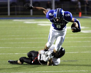  .          ROBERT  K. YOSAY | THE VINDICATOR..Polands #8  George Chammas breaks free of Canfields #8  Matt Milligan for a first down during second quarter action at Poland Dave Pavlansky Stadium..Canfield at Poland