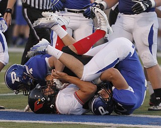  .          ROBERT  K. YOSAY | THE VINDICATOR..Canfields #9 Kimu im is stopped dead at the line by Poland #4 Dylan Garver and #2 Dom Petrony..Canfield at Poland