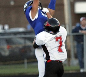  .          ROBERT  K. YOSAY | THE VINDICATOR..Polands #8  George Chammas  Jumps up for the a touchdown as #7 Nick Luchansky from Canfield trys  to defend..Canfield at Poland