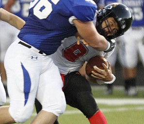. ROBERT K. YOSAY | THE VINDICATOR..Polands #56 Zach Bader crushes Canfieds #9 Kim Kim behind the line for a loss during first half action..Canfield at Poland
